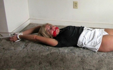 Blonde Woman Is Gagged While Her Ankles And Wrists Are Bound With Rope