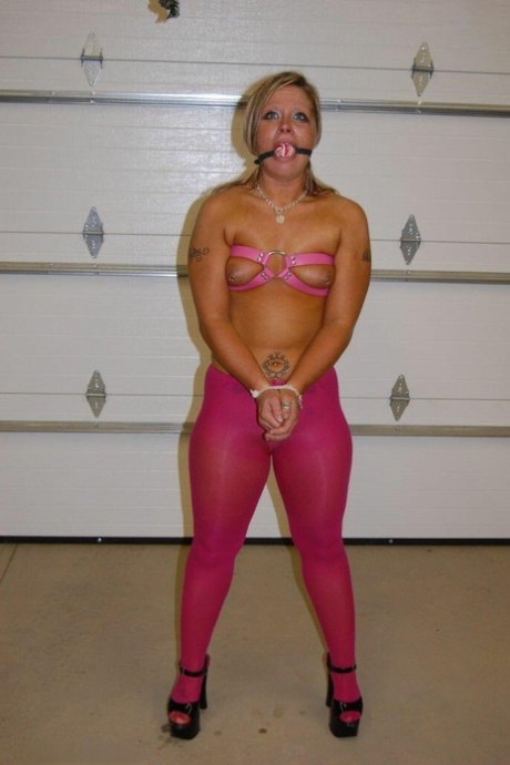 The dirty blonde performs a ball gag while wearing pink pantyhose and heels.