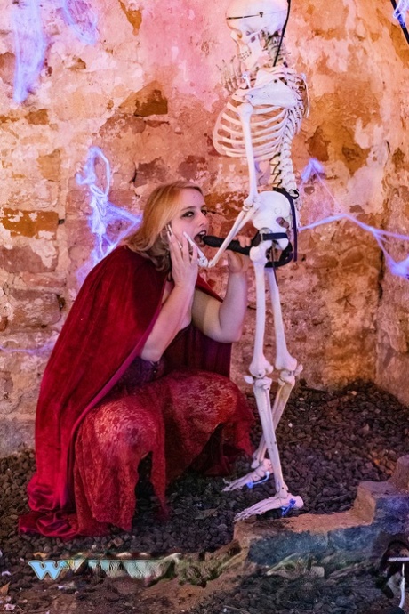 BBW Fr Lizzy, who looks blonde, is penetrated by the remains of an infected skeleton with a strap.
