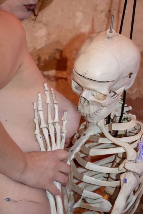 Fr Lizzy, who is blonde BBW and has been nicknamed "Bloody Bloody Free," gets into the body of a skeleton that has a strap around her.