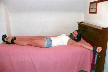 Denim cutoffs and a solo girl are being concealed in her cleaved hands on the bed.