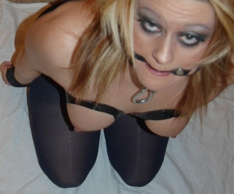 The bare girl has her pantyhose torn open and is being held tightly as she is gagged and restrained.