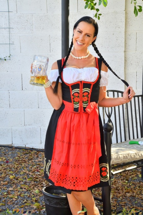 Dark-haired chick spreads her naked twat before donning Oktoberfest attire