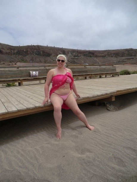 At the seaside, Barby showcases her plump figure as an older woman with platinum blonde hair.