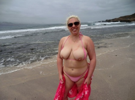 Looking svelte: Old blonde Barby exposes her plump figure at the seaside.