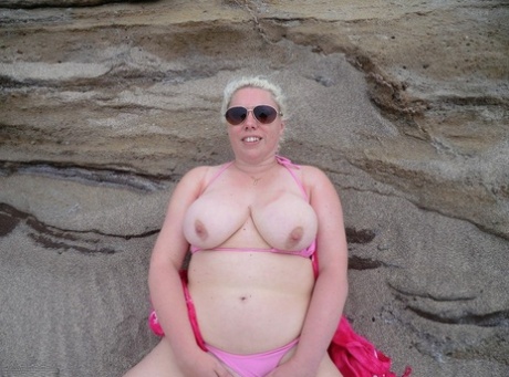 Exposed: This image features Barby, the older platinum blonde on the beach with a full stomach, showing off her plump figure.