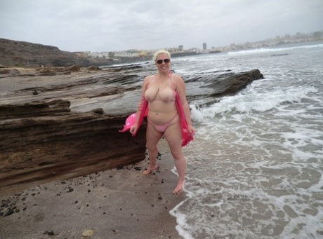 Despite her older platinum blonde locks, Barby flaunts her chubby body during a beach party.