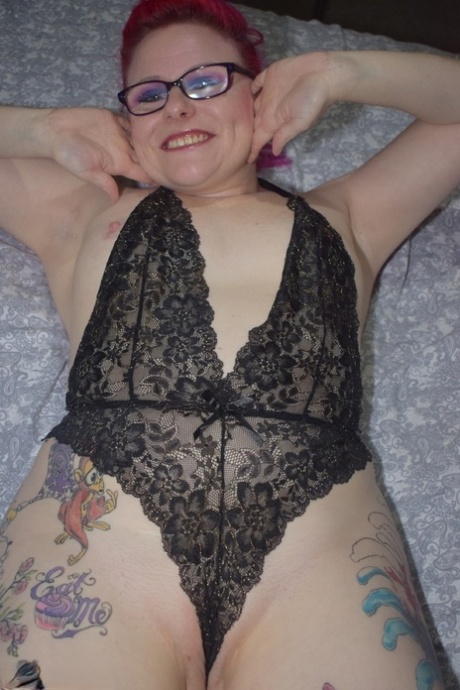 The tattoo-wearing amateur, Mollie Foxxx (pictured), poses with her glasses on and bares black lingerie.