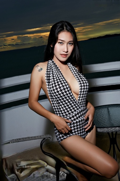 Linlin, a beautiful Asian girl, is seen naked on a balcony overlooking the sea.