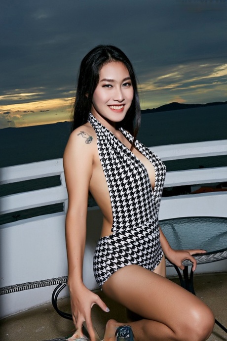 On a beachfront balcony, Linlin, a lovely Asian girl, goes completely naked.