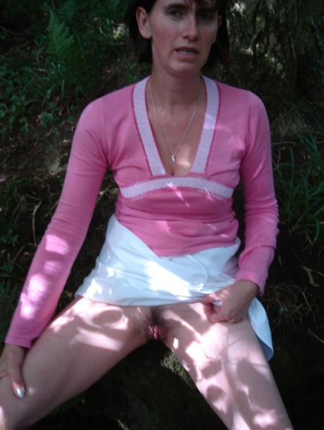 Long-stashed Slut Scot Susan licks her asses off the brush while playing in the wooded area.