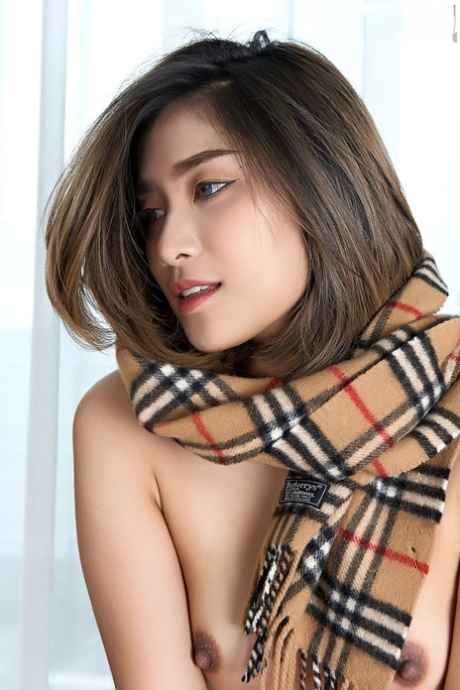 Wearing a winter scarf around her neck, Apple exposes herself to the elements as an Asian beauty.