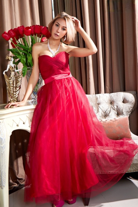 Wearing an elegant gown, the Asian beauty Pricilla displays her bare hair.