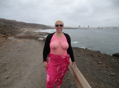 Aged Barby looses her large tits from her bodystocking by the sea, which she wears without a crotch.