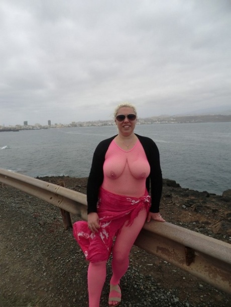 Barby, the old lady with a well-old body, loosens her large tits from her crotchless bodystocking by the sea.