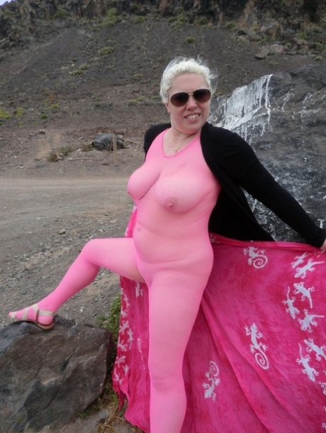 Barby, the elderly woman, loosens her large tits from a bodyless vesture by the sea.