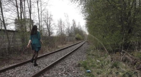 Brunette Girl Lara Pees On Concrete Blocks While Walking Railway Tracks