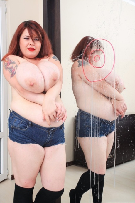 Upon reaching her 40s, Roxanne Miller, a redhead who is overweight, expels milk from her breasts into a mirror.