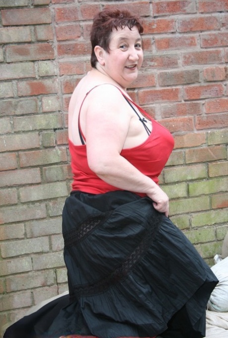 An elderly fellow named Kinky Carol dons short hair but displays her red stockings with a stylish bit of style.