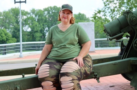 Obese and amateur goddess pear models for a SFW shoot outfitted with an artillery gun in camo.
