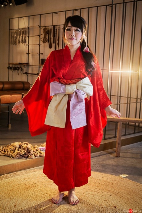 Sakura Kurokawa, a Japanese woman, is suspended from the ceiling by means of rope.