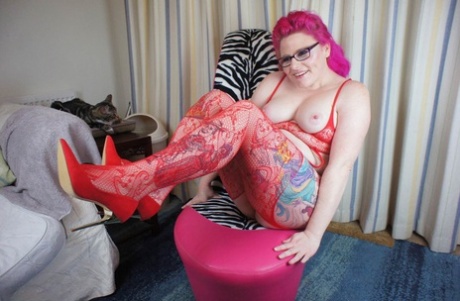 Mollie Foxxx, an inked amateur, shows her breasts while fingering herself in hosiery.