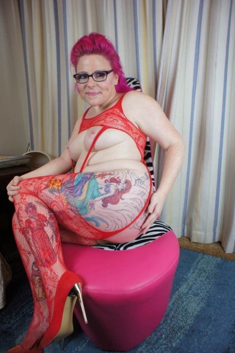 While fingering herself in hosiery, Mollie Foxxx, an amateur who has been tattooed, displays her breasts.