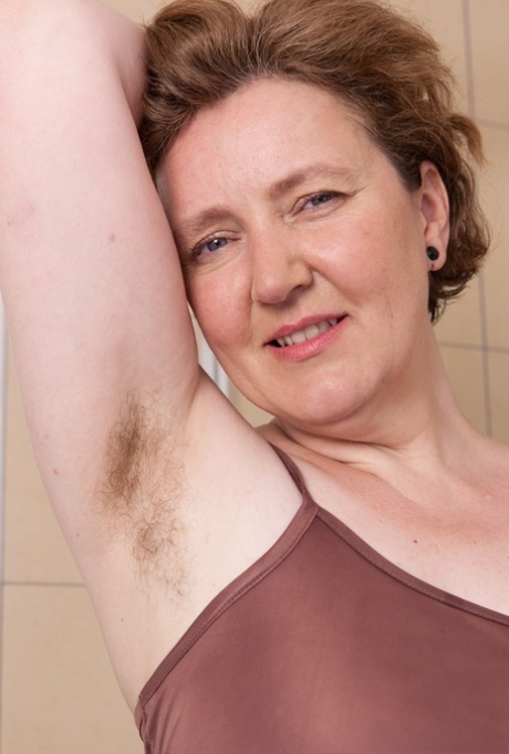 Romana Sweet displays her unshaven armpits and beard in the bathroom of a mature woman with high body fat.