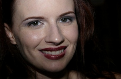 During a brutal bondage scene, Claire Adams displays her red lips.