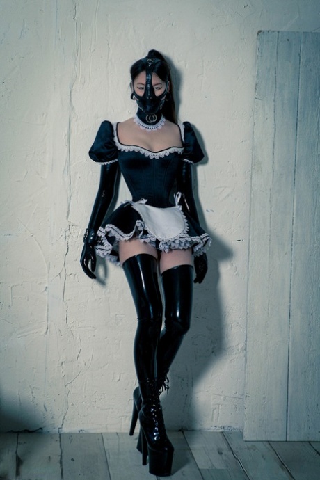 A Korean model dons an unsuitable rubber maid suit for a solo photoshoot.