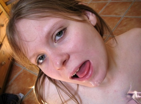 In a POV session, an amateur girl performs oral sex on her big natural breasts.
