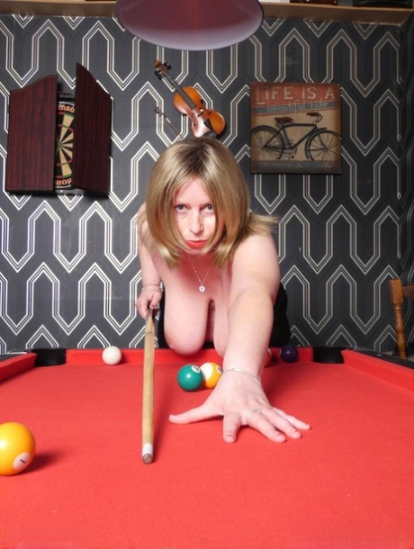 As she shoots pool toplessly in a bar with big-tited older blonde hair, Posh Sophia is seen without her top touching the floor.