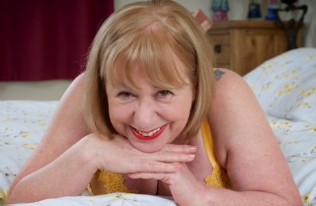 Mature British Amateur Speedy Bee Fingers Her Pussy On A Bed In Tan Stockings