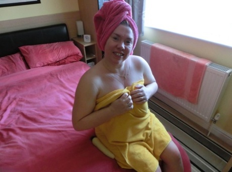 A vibrator stimulates the masturbation reflex of Barby, a mature blonde, after taking a shower.
