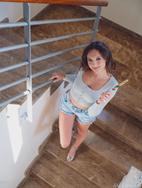 Young brunette Isabela De Laa showcases her trimmed pussy in a stairwell