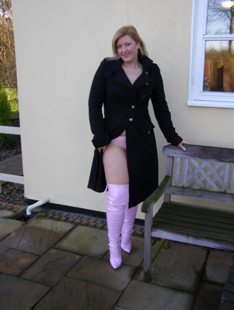 Out in force: Amateur BBW Samantha poses nude in over the knee latex boots at her house.