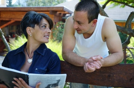 An adult female with a brief hairstyle engages in sexual activity with her toy boy, engaging in hardcore sex.