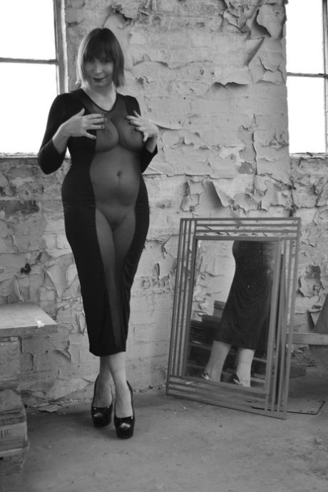 A black-and-white performance by Barby Slut involves the use of a see-thru dress by a middle aged woman.