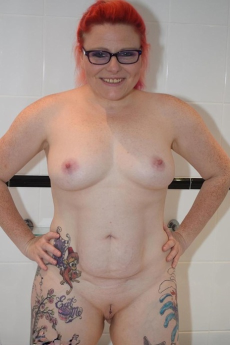 The tattooed body of Mollie Foxxx, an older redhead who is still active, is being exhibited in the bathroom.