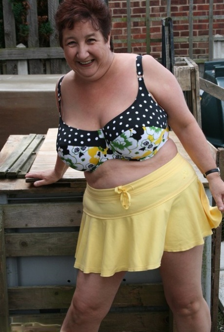 Patio stones: Thick, older woman Kinky Carol dresses in a bikini.