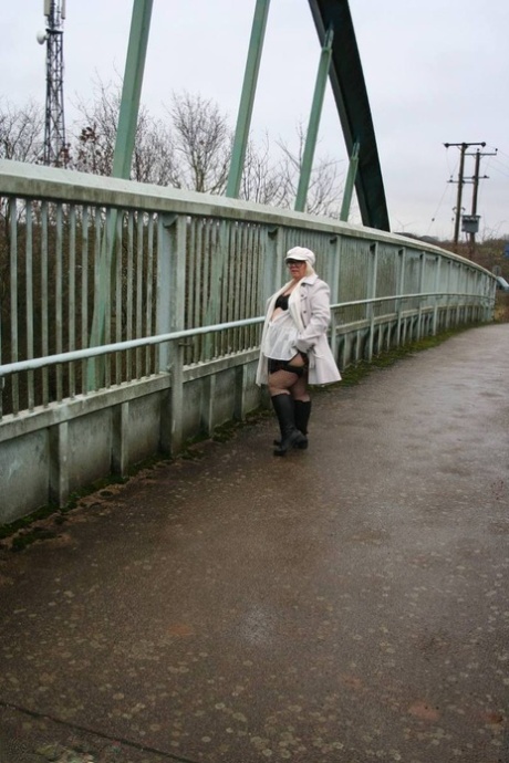 The UK's Lexie Cummings, a fat woman, displays her large buttocks on a bridge for pedestrians.