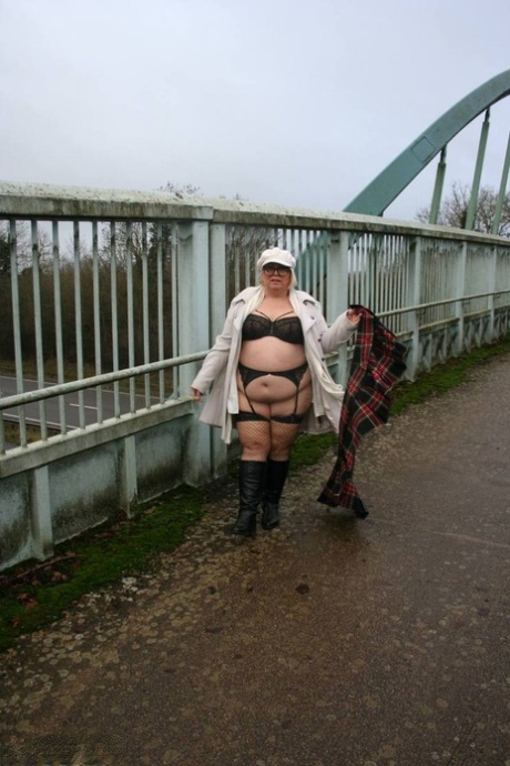 On a pedestrian bridge, Lexie Cummings displays her large buttocks, having been raised in the face by a fat woman from the UK.