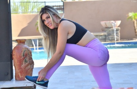Following her stretching session in workout clothes, Ellie's dirty blonde hair gives her pussy.