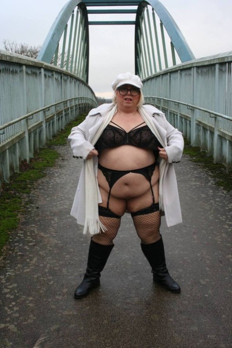 Fat British woman Lexie Cummings lays down on the bridge for pedestrians.