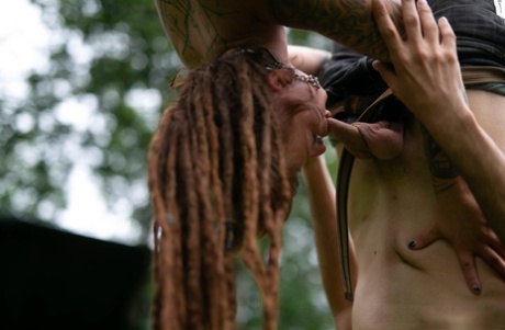 A tattooed couple, Andreaz & Burbz Z, are hanging upside down in a yard display.