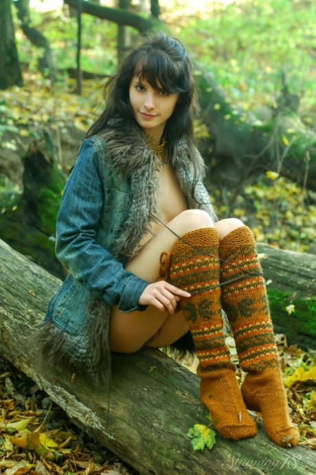 Young brunette Eldoris Q exhibit her tits and pussy in the middle of a forest.