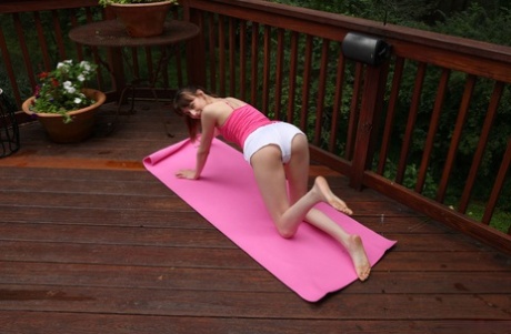 While doing yoga on a deck, young girl with flexibility named Lana Smalls gets naked.