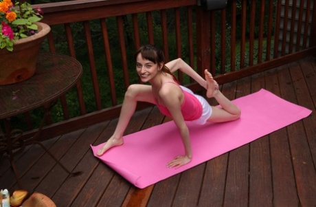 Lana Smalls, a young and flexible girl, is seen getting naked while doing yoga on a deck.