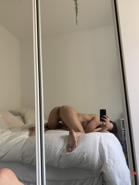 Taking a snap of her nude selfies, Abbie Maley shows off the backside and then proceeds to grab hold of her bare ass.