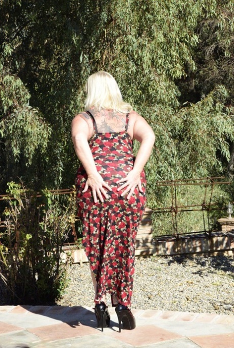 In the midst of outdoor activities, fat blonde granny Melody looses her large buttocks from wearing a dress.